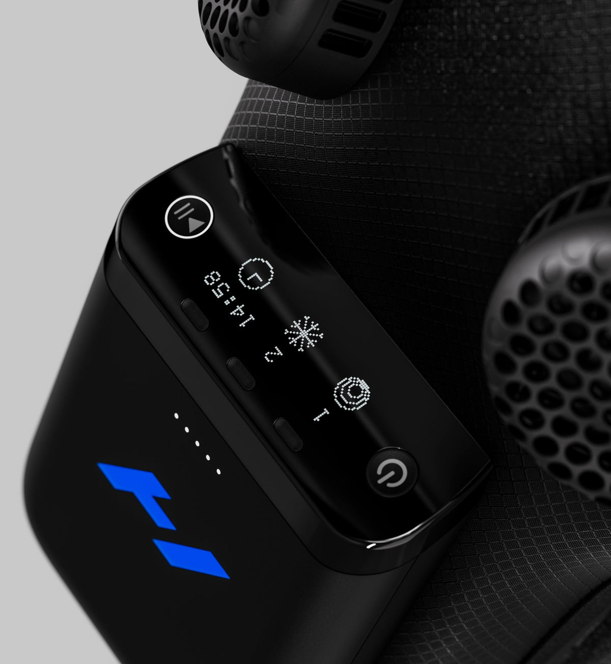 Close up shot of the control panel of a hyperice x 2 device with buttons and display on a textured surface.