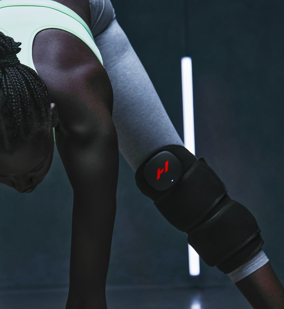 Person stretching, wearing a venom 2 leg on a dark background
