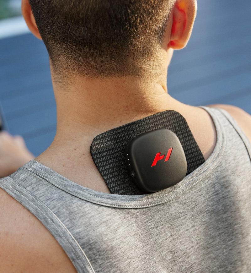 Person wearing a venom go pad and pod on the back of his neck with a blurred background